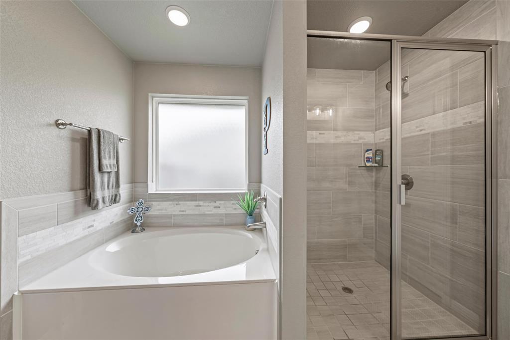 828 Agile Street Hewitt, TX 76643 - Photo 26 of 30 a white bath tub sitting next to a shower