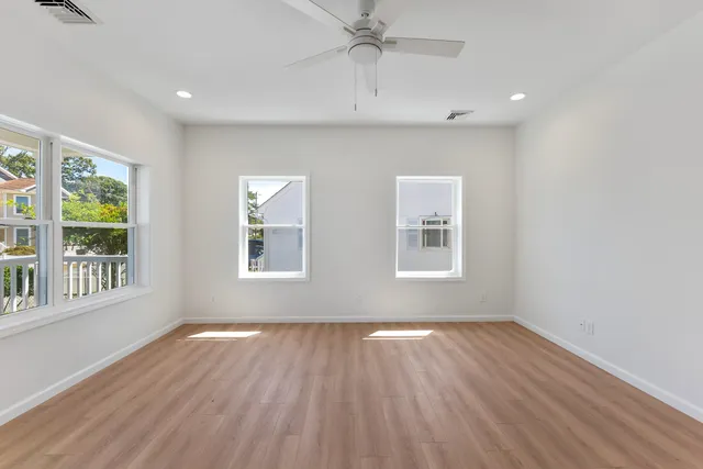 a large kitchen with kitchen island a sink a stove a microwave a center island and cabinets