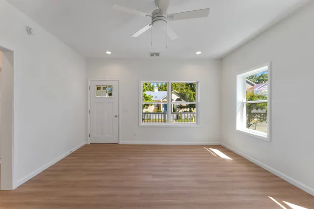 a view of a kitchen with a sink and refrigerator