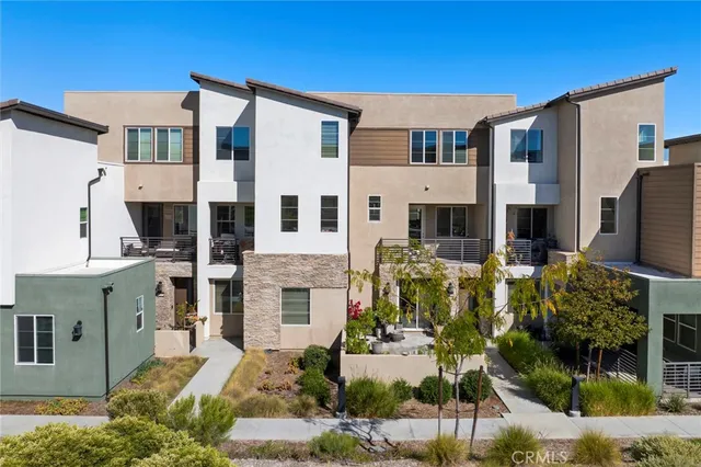 a front view of residential houses with outdoor space