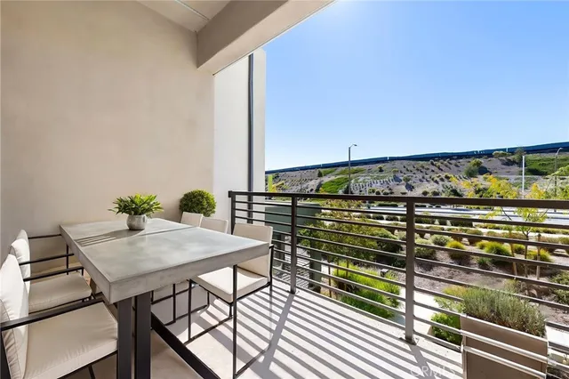 a view of a balcony with table and chairs