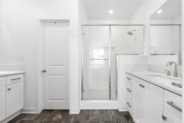 a bathroom with a shower sink and mirror