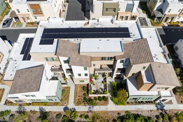 an aerial view of a house with a yard