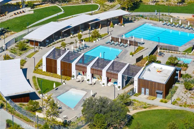 an aerial view of a house a swimming pool and outdoor seating