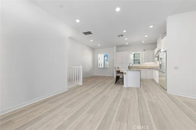 a view of kitchen with wooden floor and electronic appliances