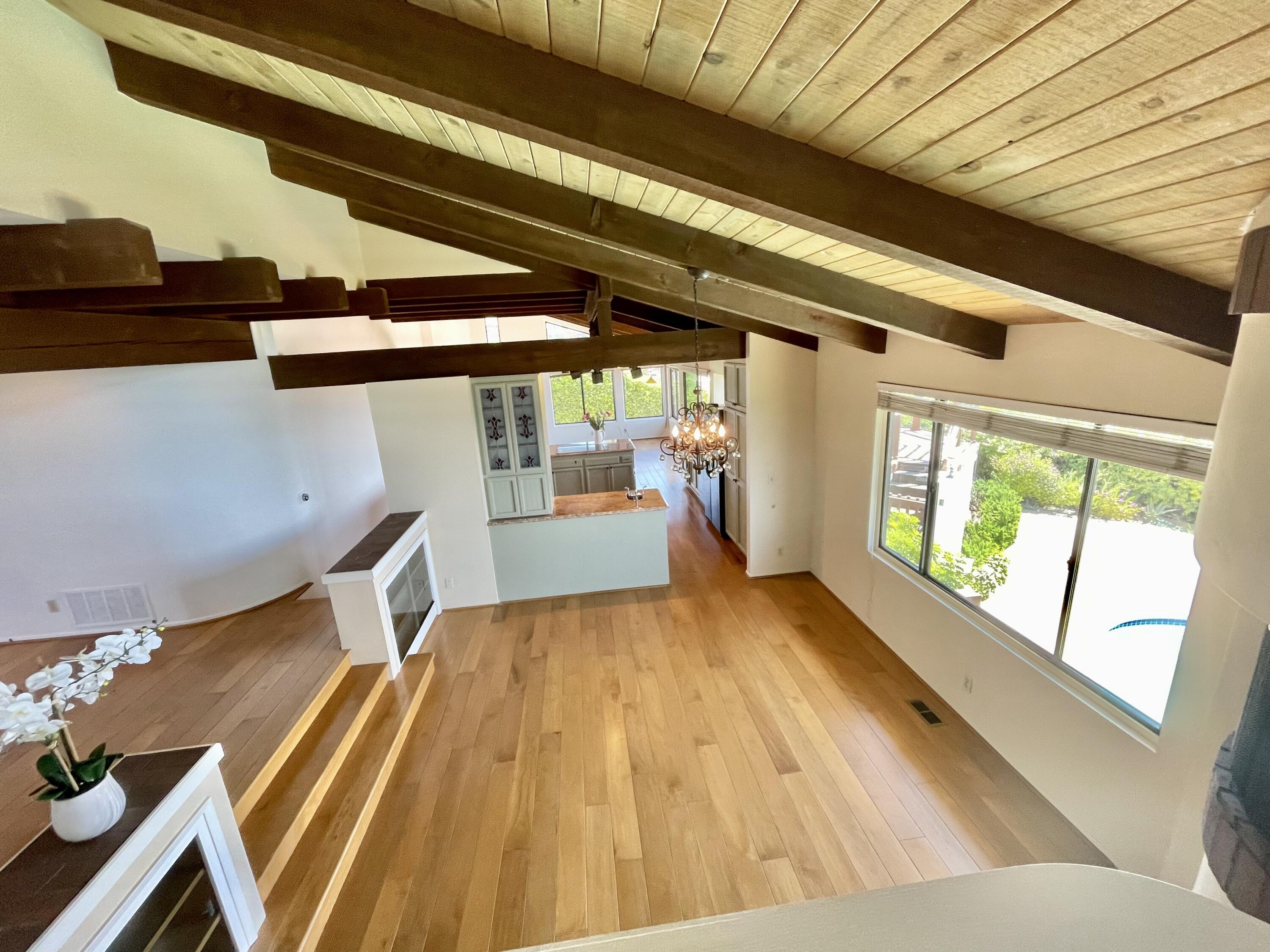 260 Loma Media Road Santa Barbara, CA 93103 - Photo 4 of 23 a view of an empty room with wooden floor and a window