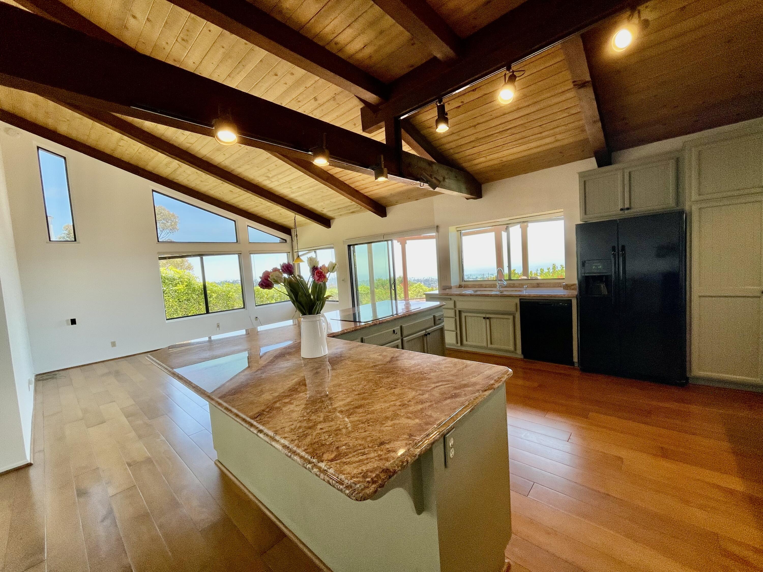 260 Loma Media Road Santa Barbara, CA 93103 - Photo 8 of 23 a kitchen with stainless steel appliances granite countertop a sink a stove and a wooden floors