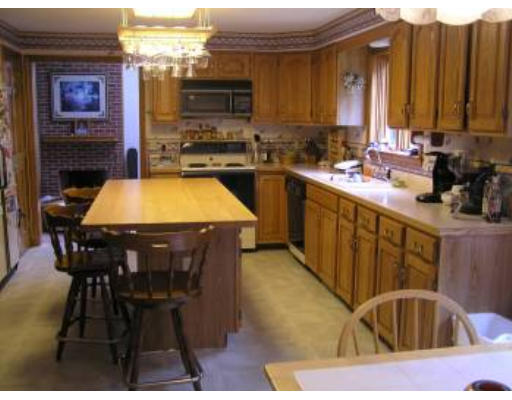 16 Michigan Road Tyngsborough, MA 01879 - Photo 6 of 8 a kitchen with stainless steel appliances a sink a stove a table and chairs