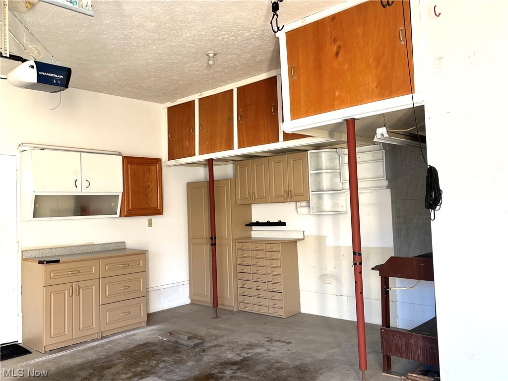 720 A Springfield Road Columbiana, OH 44408 - Photo 26 of 28 Garage with a garage door opener and storage