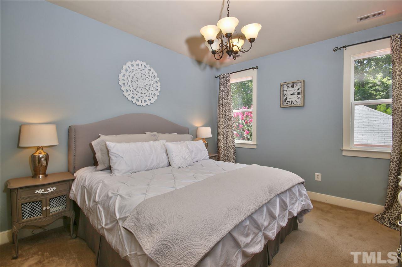 4522 All Points View Way Raleigh, NC 27614 - Photo 12 of 25 a bedroom with a large bed and a chandelier