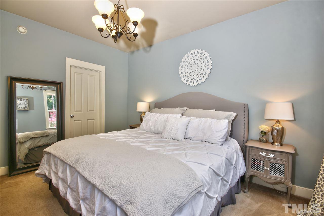 4522 All Points View Way Raleigh, NC 27614 - Photo 14 of 25 a bedroom with a bed and a chandelier