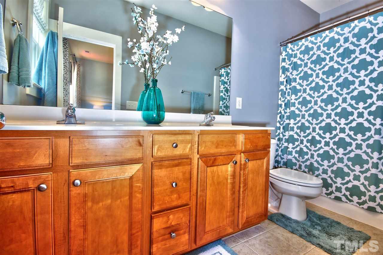 4522 All Points View Way Raleigh, NC 27614 - Photo 15 of 25 a bathroom with a granite countertop toilet a sink and a mirror