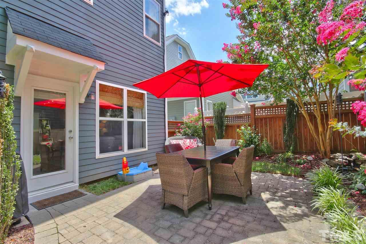 4522 All Points View Way Raleigh, NC 27614 - Photo 23 of 25 a view of a patio with table and chairs under an umbrella