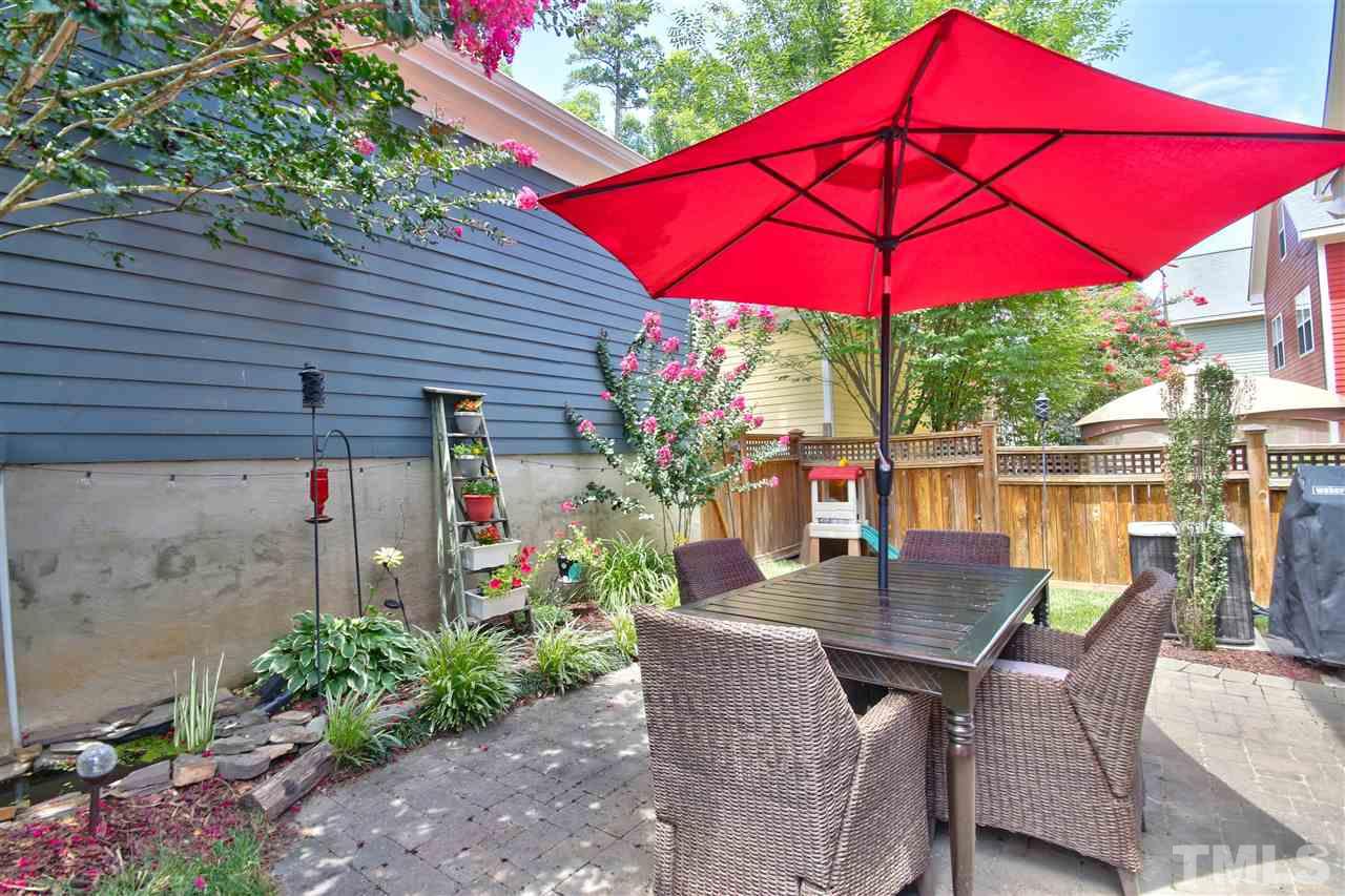 4522 All Points View Way Raleigh, NC 27614 - Photo 25 of 25 a patio with tables and chairs and a umbrella