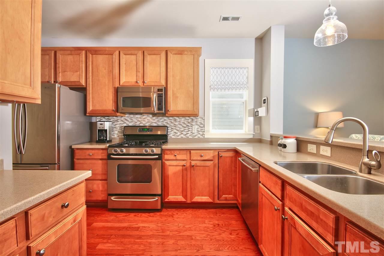 4522 All Points View Way Raleigh, NC 27614 - Photo 7 of 25 a kitchen with stainless steel appliances granite countertop a stove a sink and a microwave