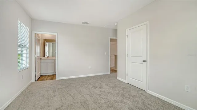 a view of house with yard and a street