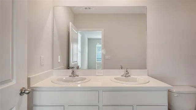 a kitchen with a dining table chairs sink and natural light