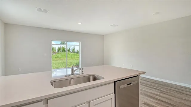 a view of a patio with table and chairs and potted plants