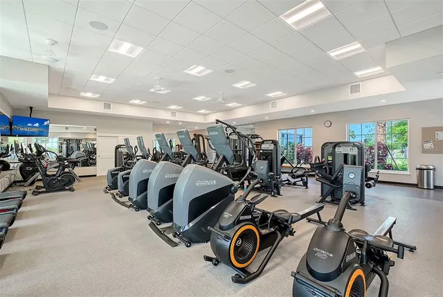 a room with pool table and windows