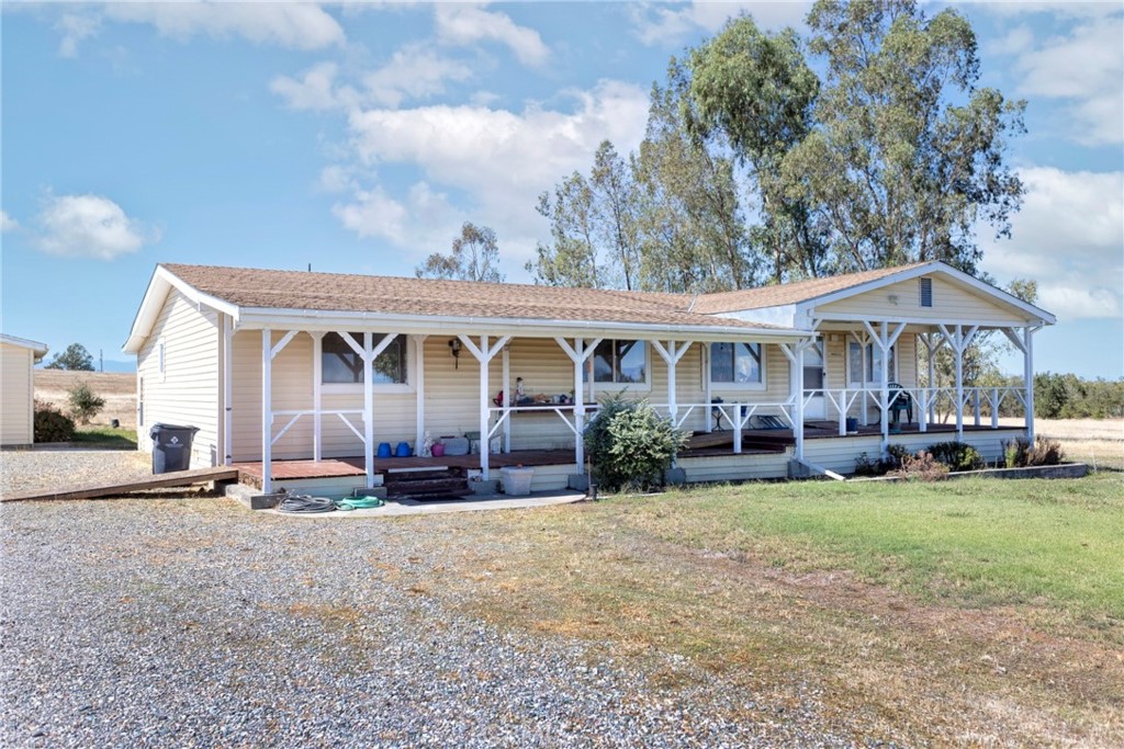 5867 Keene Road Corning, CA 96021 - Photo 1 of 1 a front view of a house with swimming pool and porch with furniture