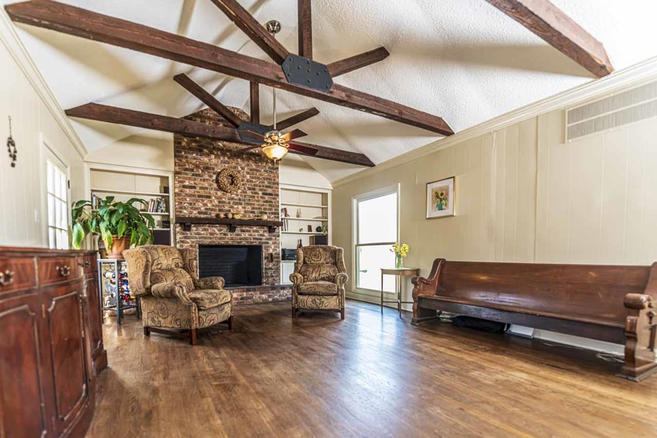 6746 Old Millington Road Millington, TN 38053 - Photo 17 of 40 Living room featuring a brick fireplace, beamed ceiling, dark wood-style flooring, ornamental molding, and built in shelves