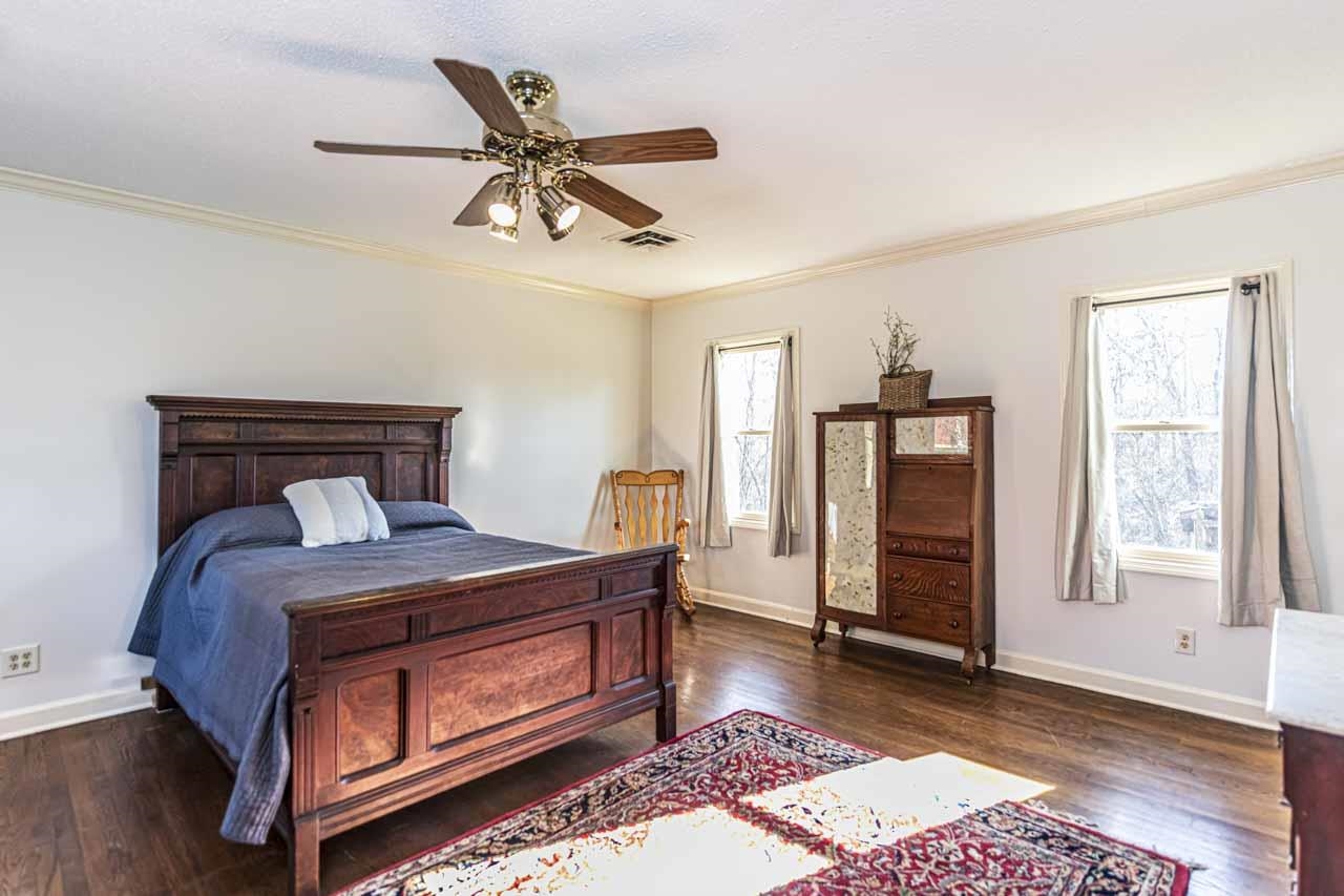 6746 Old Millington Road Millington, TN 38053 - Photo 18 of 40 Bedroom with crown molding, dark wood-type flooring, and ceiling fan