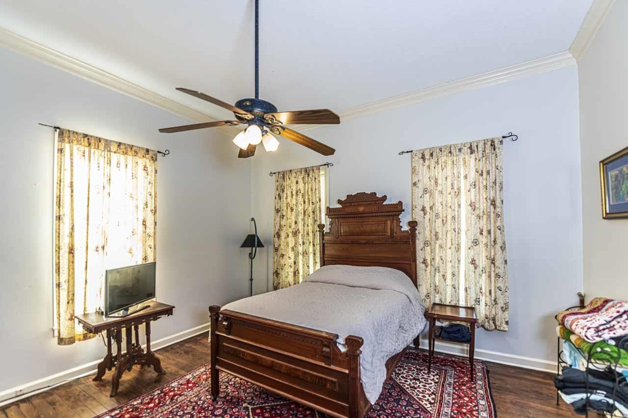 6746 Old Millington Road Millington, TN 38053 - Photo 19 of 40 a bedroom with a bed and a chandelier
