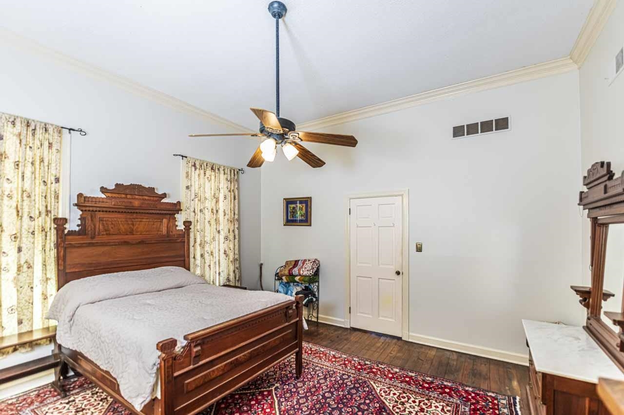 6746 Old Millington Road Millington, TN 38053 - Photo 20 of 40 Bedroom with ornamental molding, dark wood finished floors, and ceiling fan
