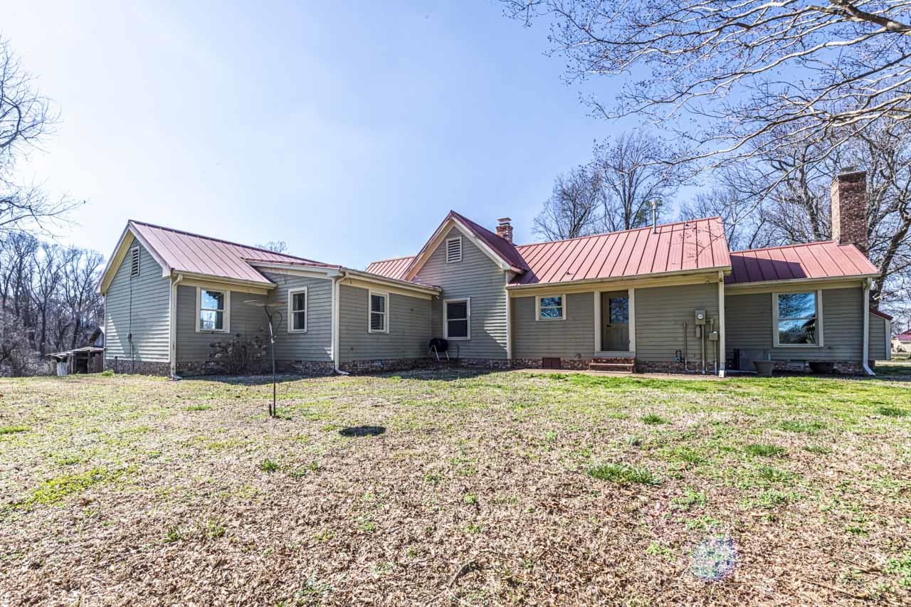 6746 Old Millington Road Millington, TN 38053 - Photo 2 of 40 Rear view of house with a chimney, a lawn, and a standing seam roof