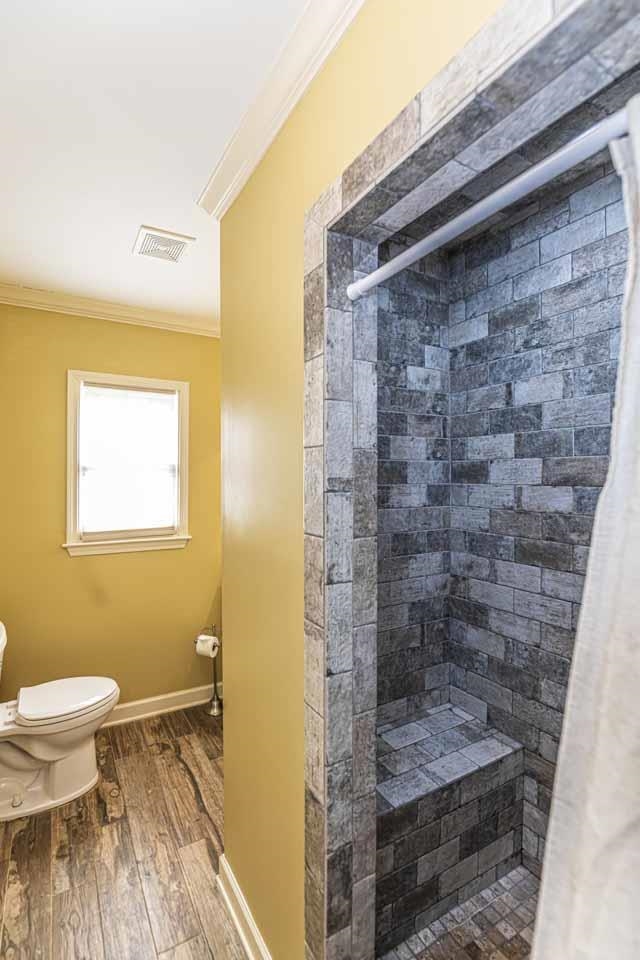 6746 Old Millington Road Millington, TN 38053 - Photo 23 of 40 Full bathroom with crown molding, a shower stall, and wood finished floors