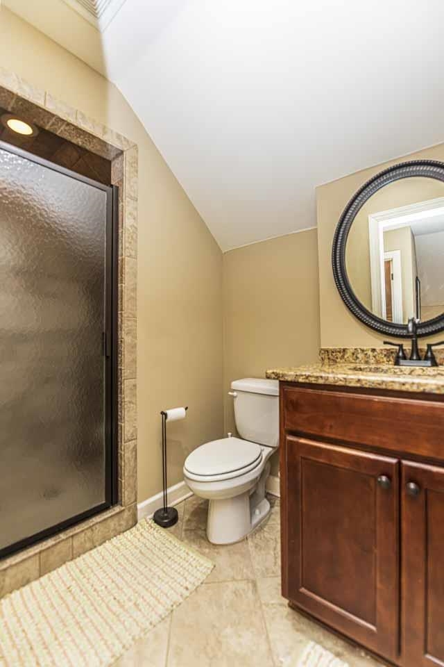 6746 Old Millington Road Millington, TN 38053 - Photo 26 of 40 Full bathroom with vanity, a shower stall, lofted ceiling, and light tile patterned floors