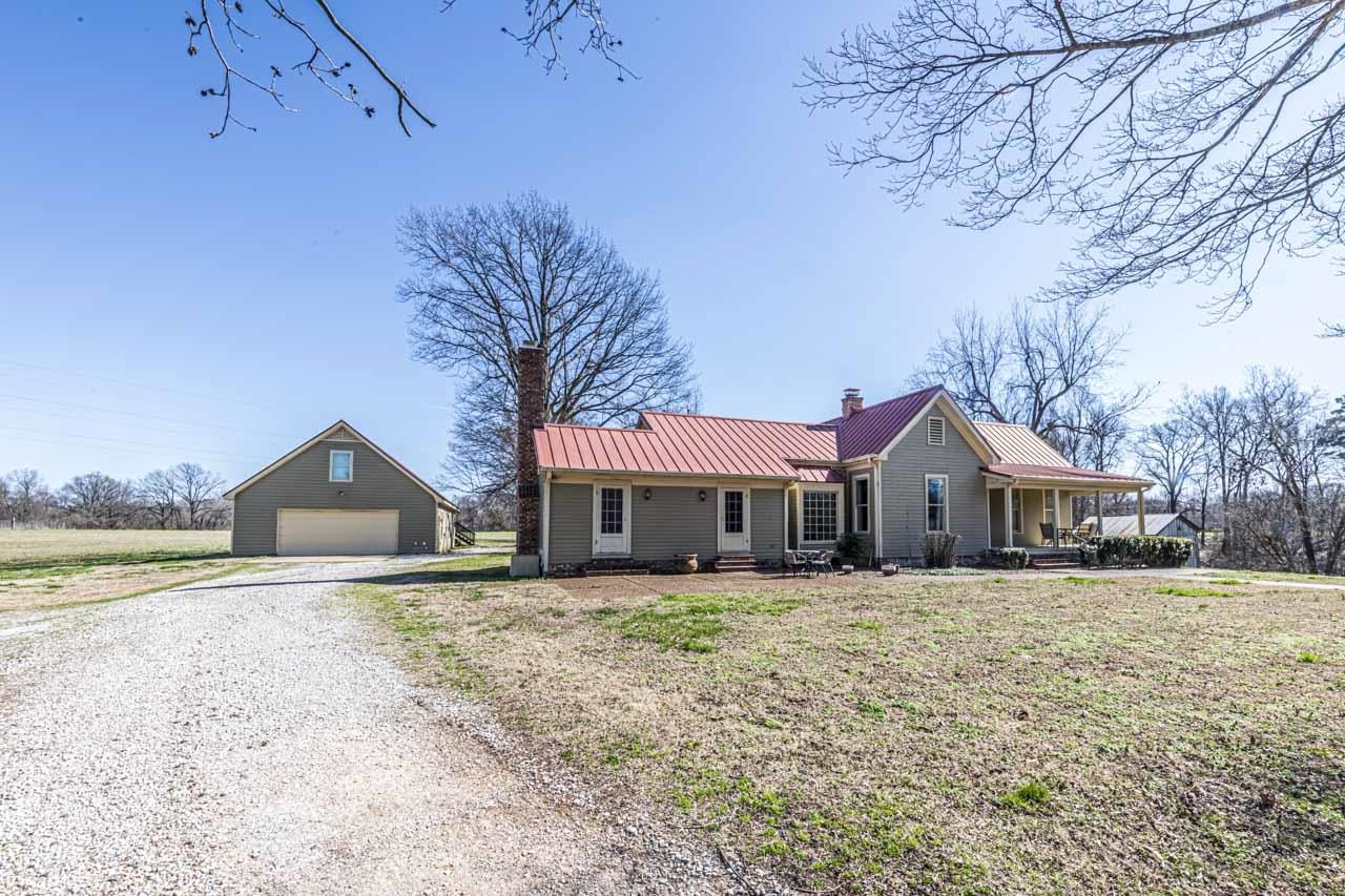 6746 Old Millington Road Millington, TN 38053 - Photo 4 of 40 View of front of property featuring an outbuilding, a metal roof, a chimney, a garage, and covered porch