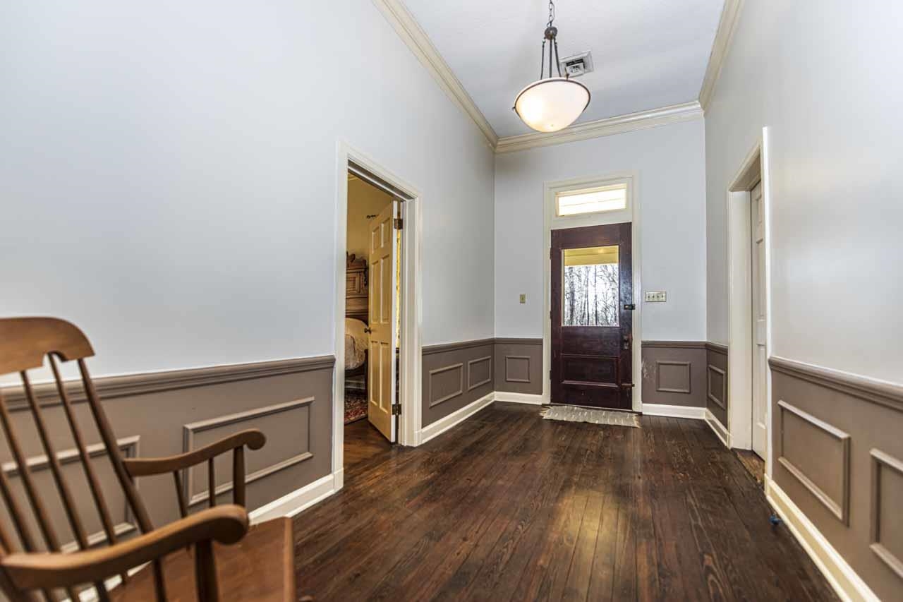 6746 Old Millington Road Millington, TN 38053 - Photo 7 of 40 Entrance foyer featuring ornamental molding, dark wood-type flooring, and a wainscoted wall