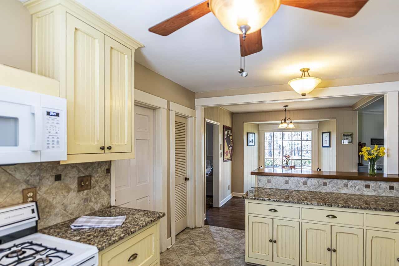6746 Old Millington Road Millington, TN 38053 - Photo 10 of 40 Kitchen featuring cream cabinetry, white appliances, and a ceiling fan