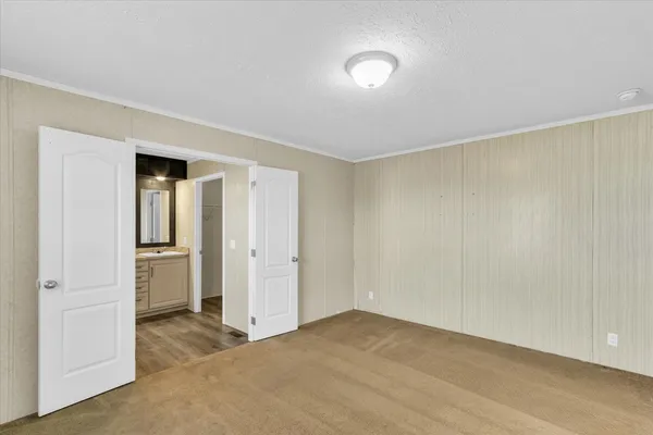 a view of an empty room and closet area