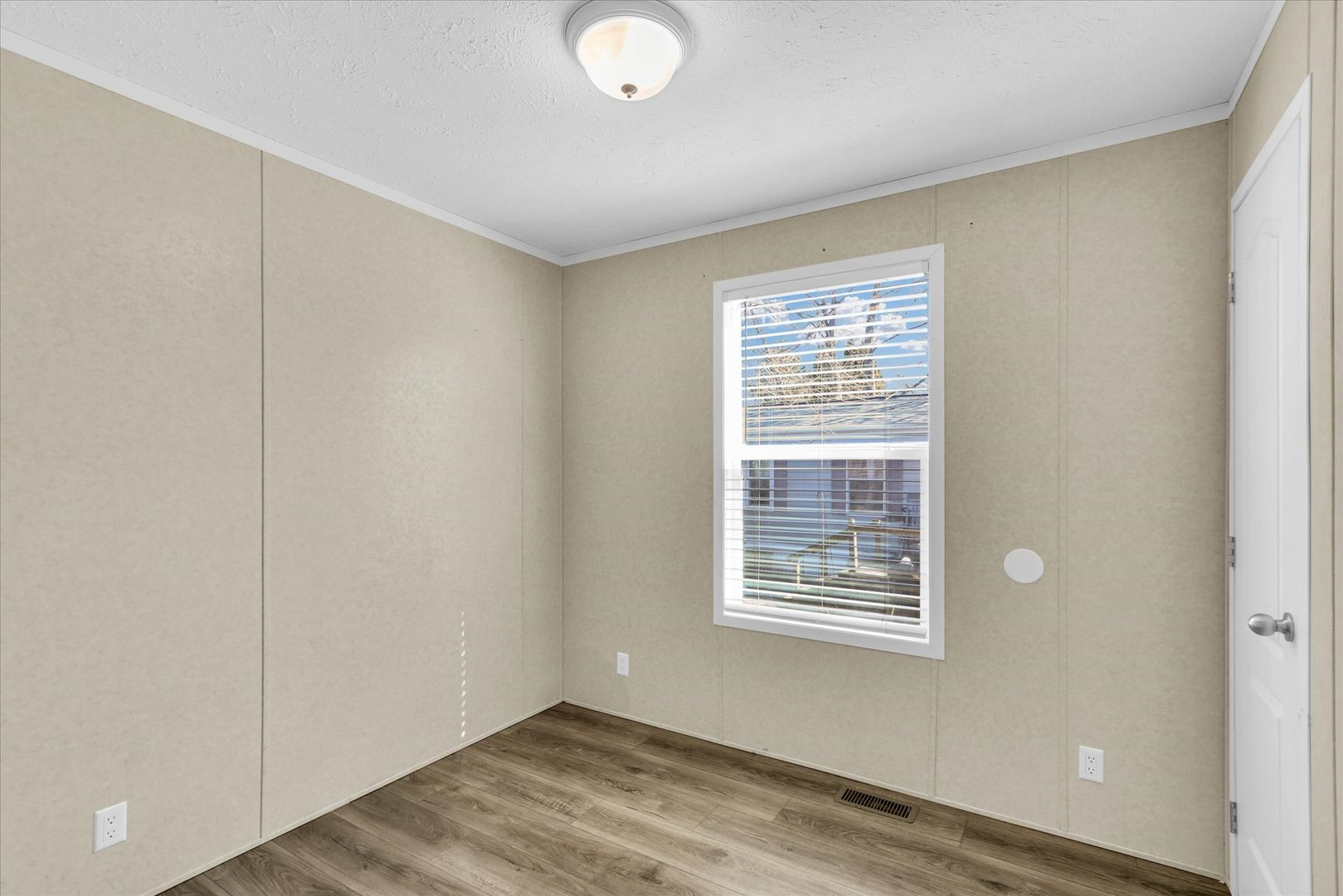 1205 Wedgewood Drive Rantoul, IL 61866 - Photo 22 of 31 a view of an empty room with wooden floor and a window