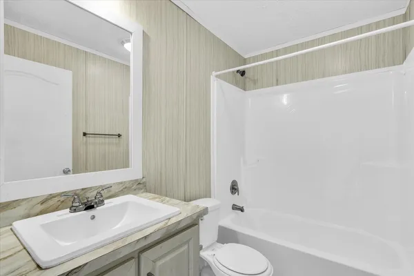 a bathroom with a sink toilet tub and shower