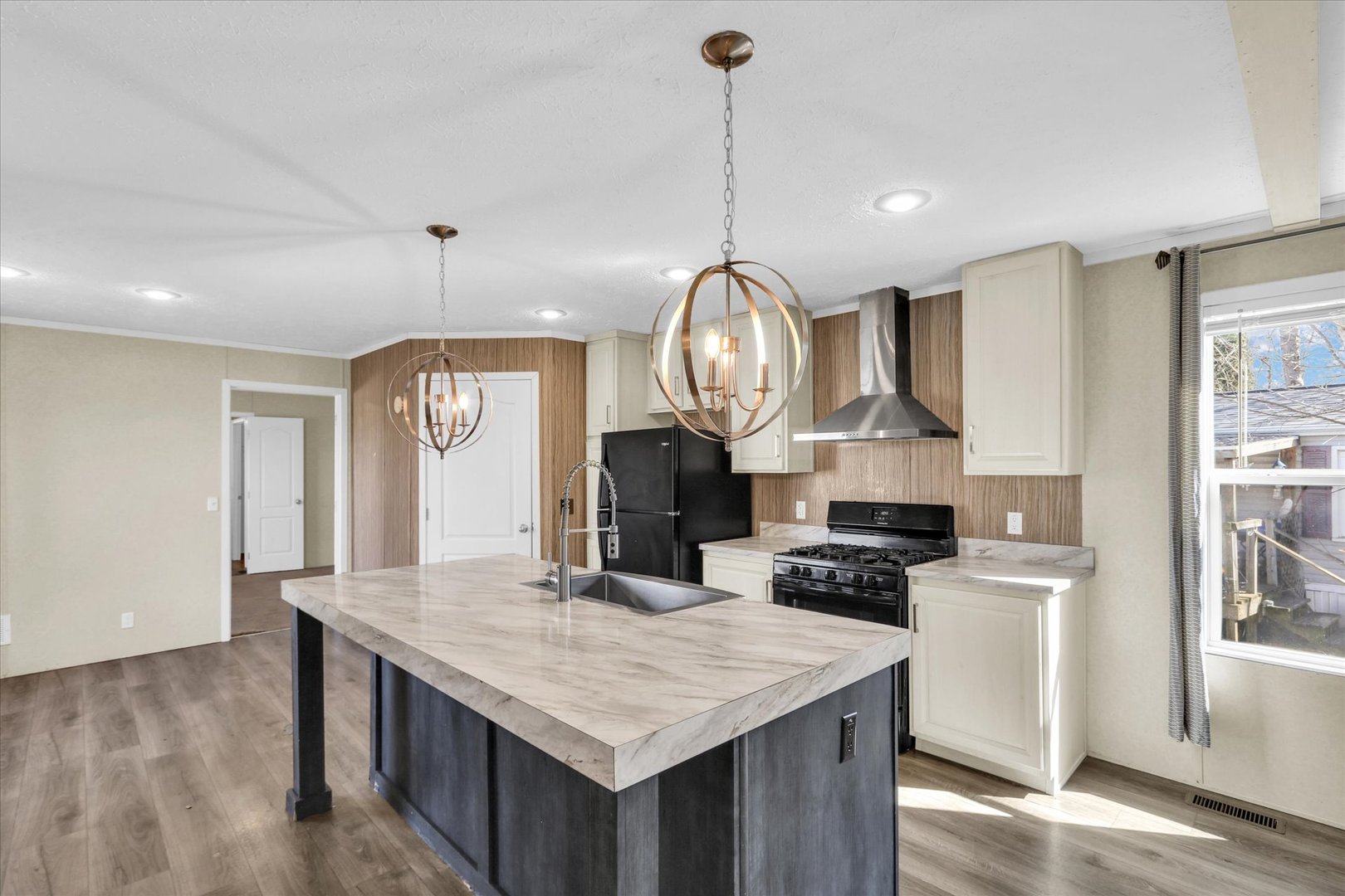 1205 Wedgewood Drive Rantoul, IL 61866 - Photo 4 of 31 a kitchen with stainless steel appliances granite countertop a stove a refrigerator a kitchen island a sink dishwasher and white cabinets with wooden floor