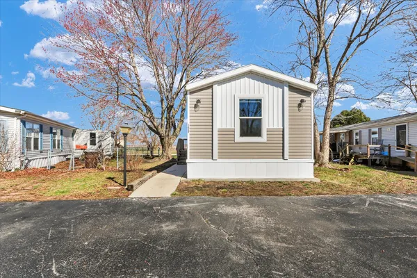a view of a house with a yard covered in snow