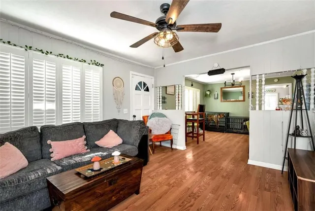 a living room with furniture and wooden floor