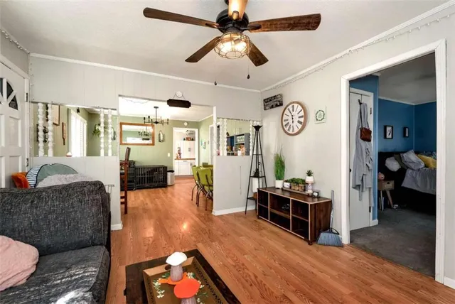 a living room with furniture and wooden floor
