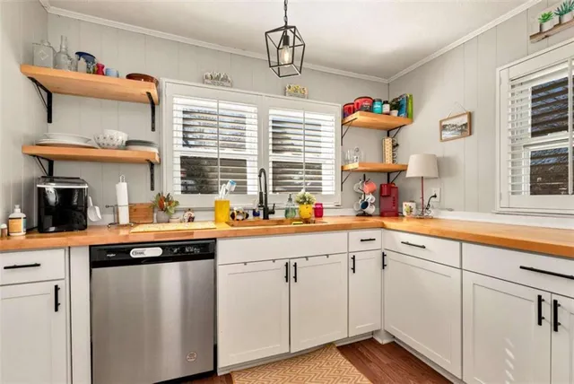 a kitchen with white cabinets and a sink