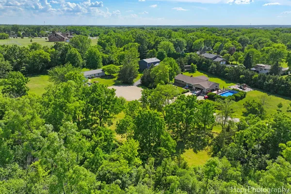 an aerial view of a house with a yard