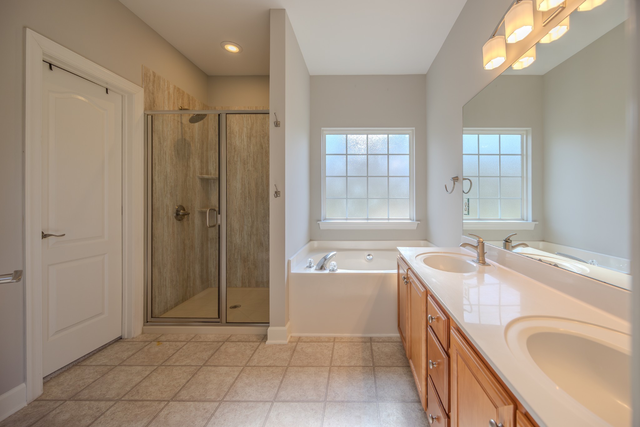 3545 Rock Springs Road Smyrna, TN 37167 - Photo 14 of 23 a bathroom with a granite countertop sink a mirror a bathtub and next to a window