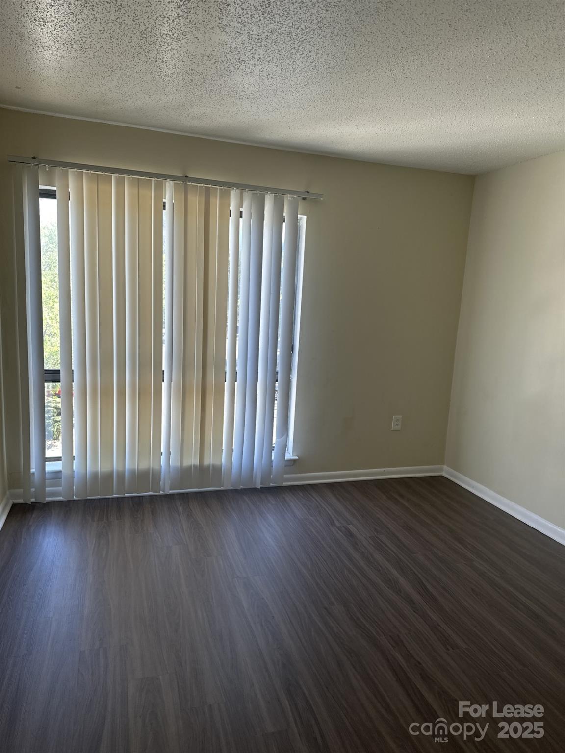 4816 Spring Lake Drive, Unit E Charlotte, NC 28212 - Photo 12 of 14 wooden floor in an empty room with a window