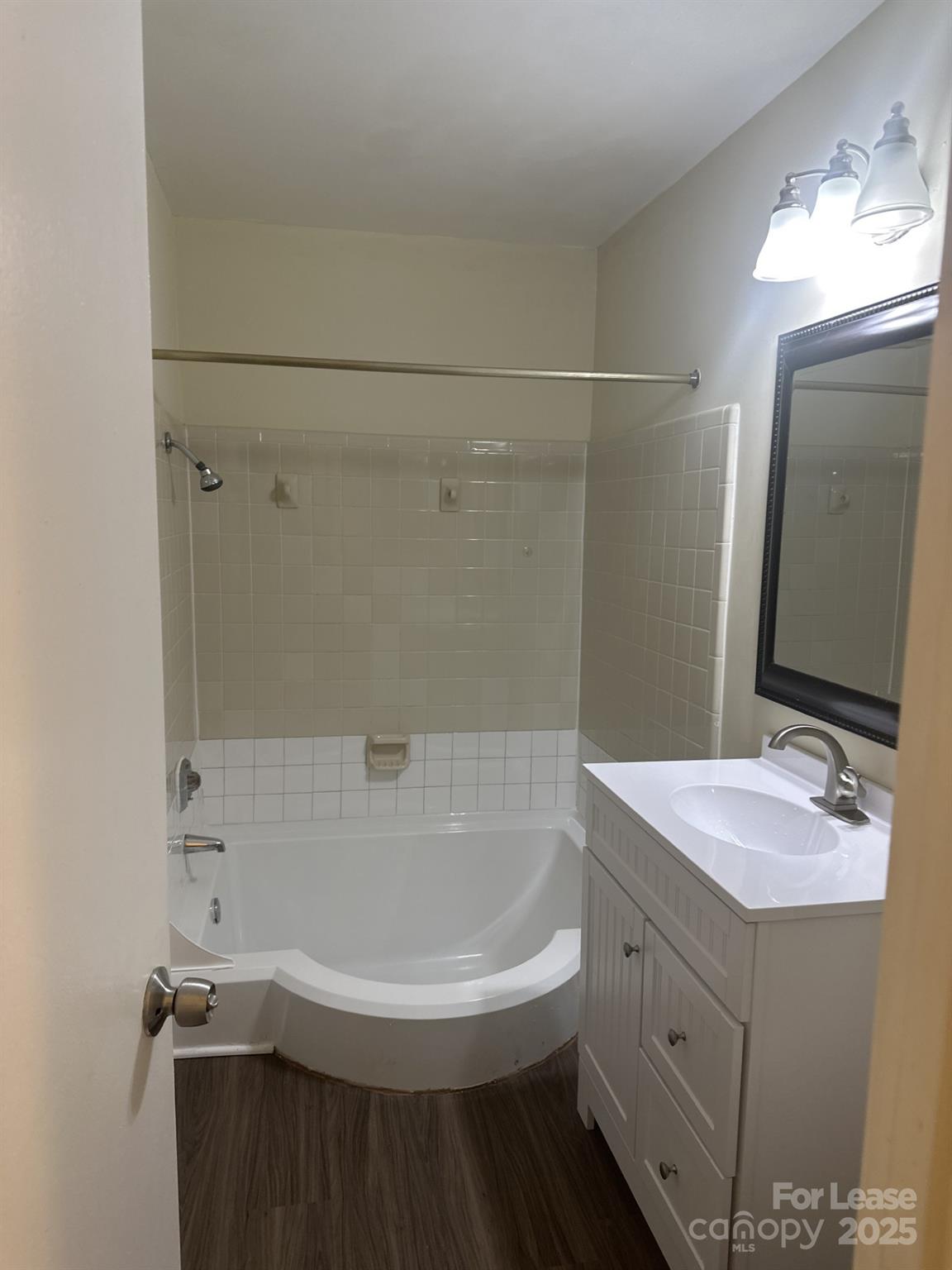 4816 Spring Lake Drive, Unit E Charlotte, NC 28212 - Photo 14 of 14 a bathroom with a bathtub and a sink