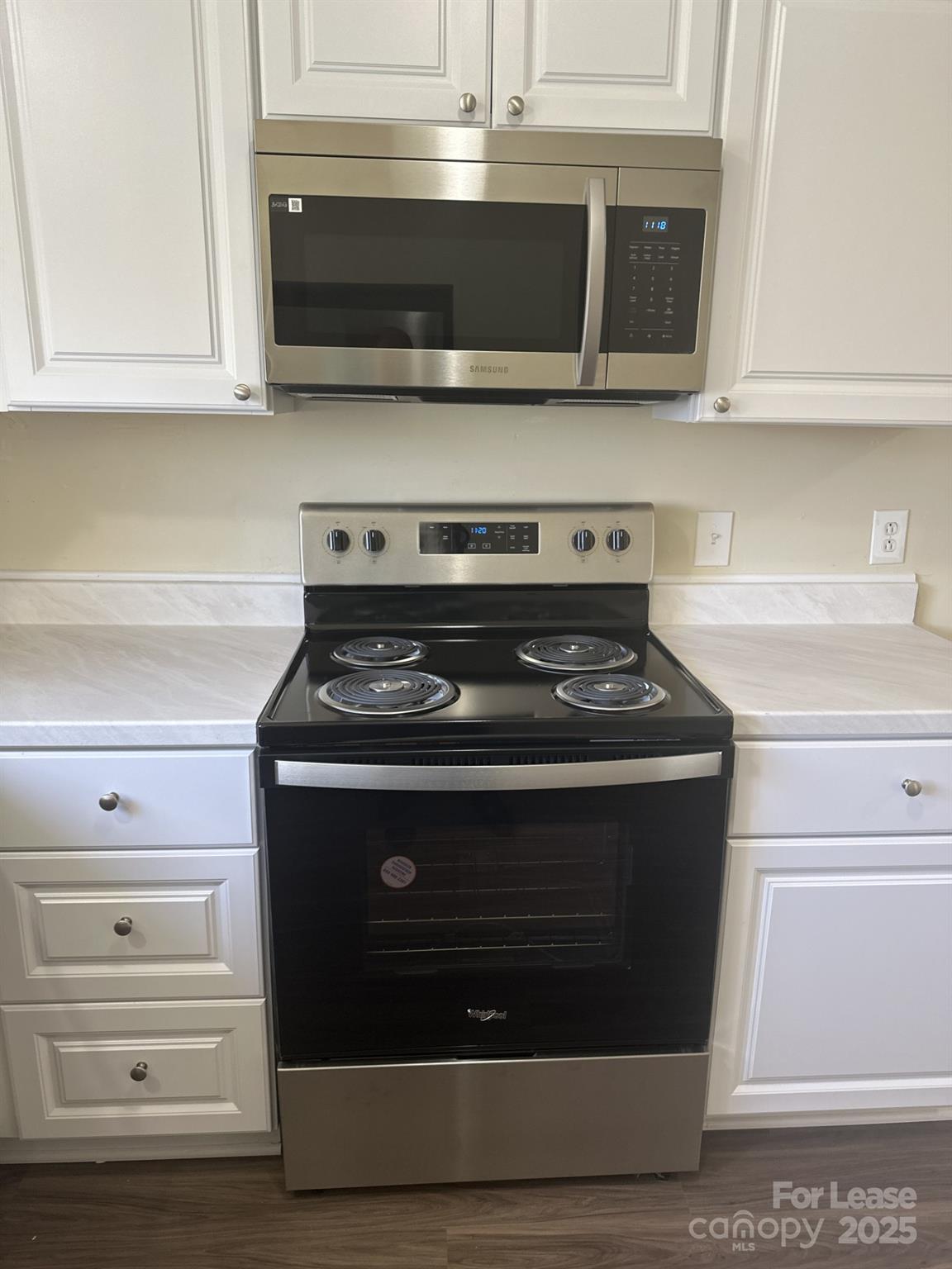 4816 Spring Lake Drive, Unit E Charlotte, NC 28212 - Photo 3 of 14 a stove top oven sitting inside of a kitchen
