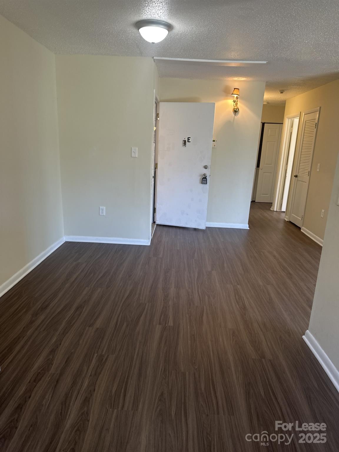 4816 Spring Lake Drive, Unit E Charlotte, NC 28212 - Photo 4 of 14 a view of a hallway with wooden floor