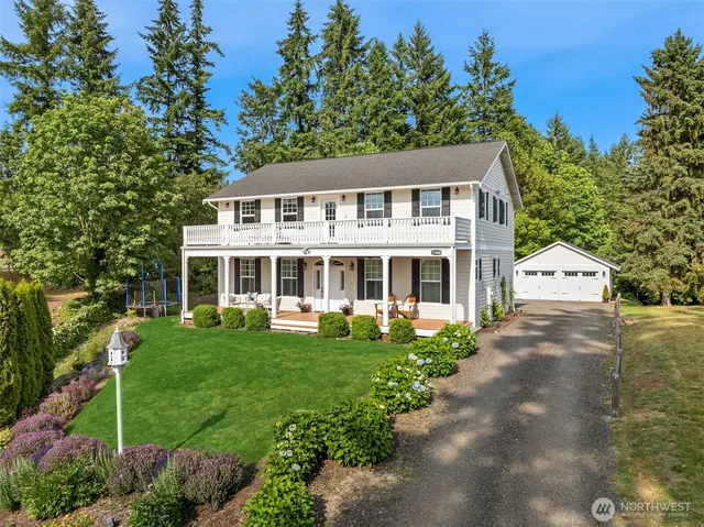 a front view of a house with a yard table and chairs