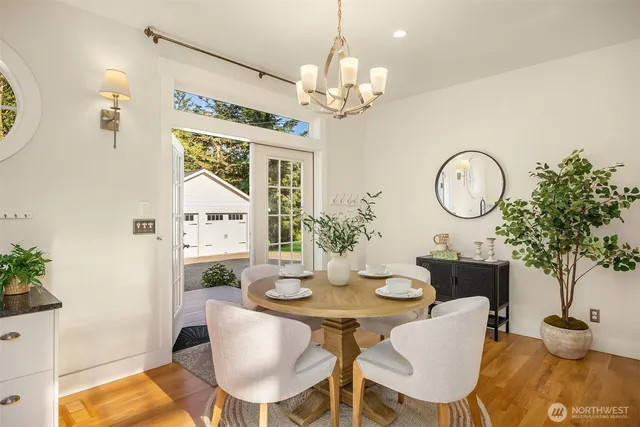 a view of a dining room with furniture and chandelier